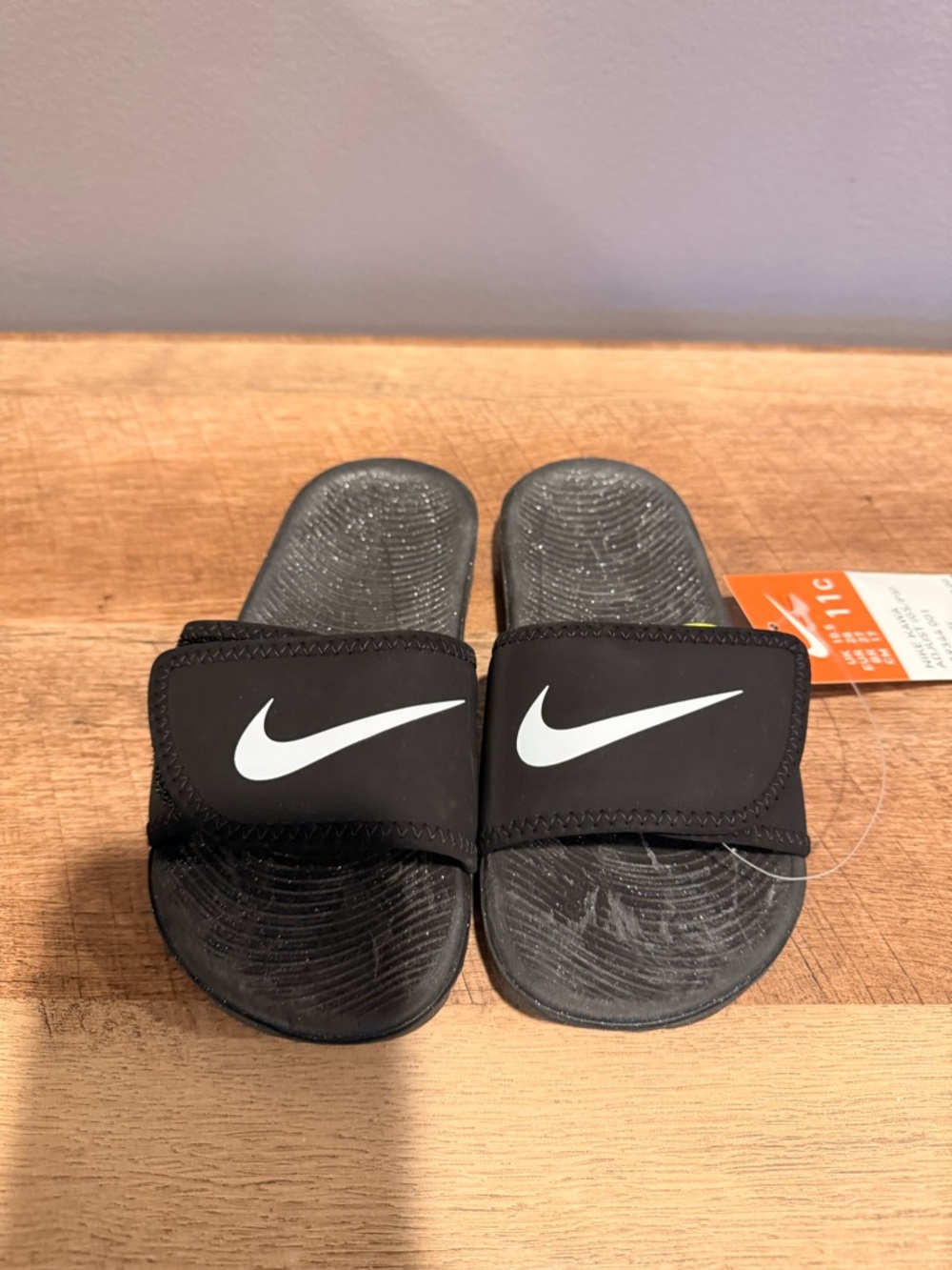 Nike Kids Black Slide Sandals with White Swoosh Logo